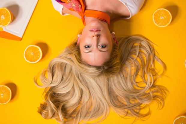 lady with hair vitamins and supplements yellow background